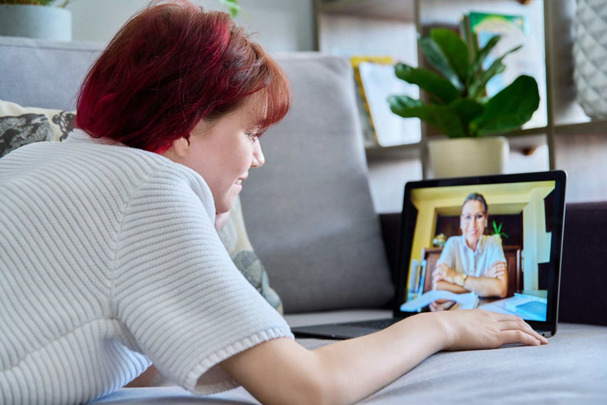 Online therapy session of teenage female with psychologist